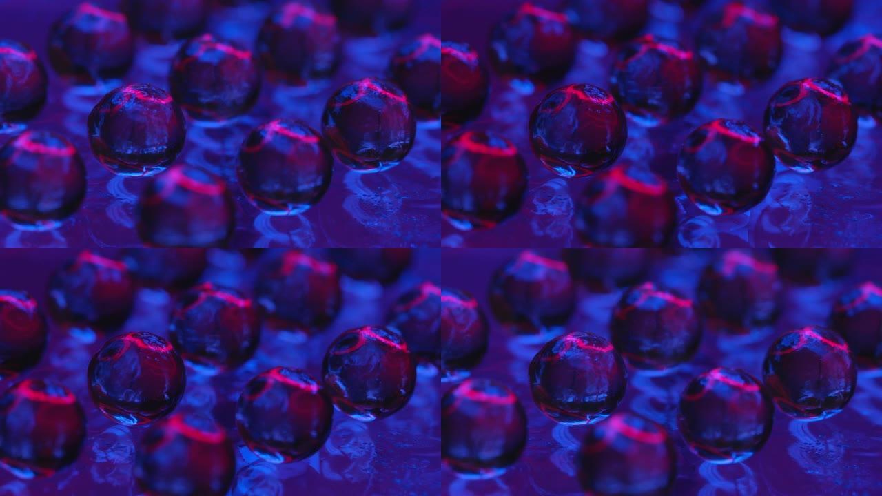 光滑表面上的透明玻璃球。美丽的光穿过它们，它们被折射和反射。