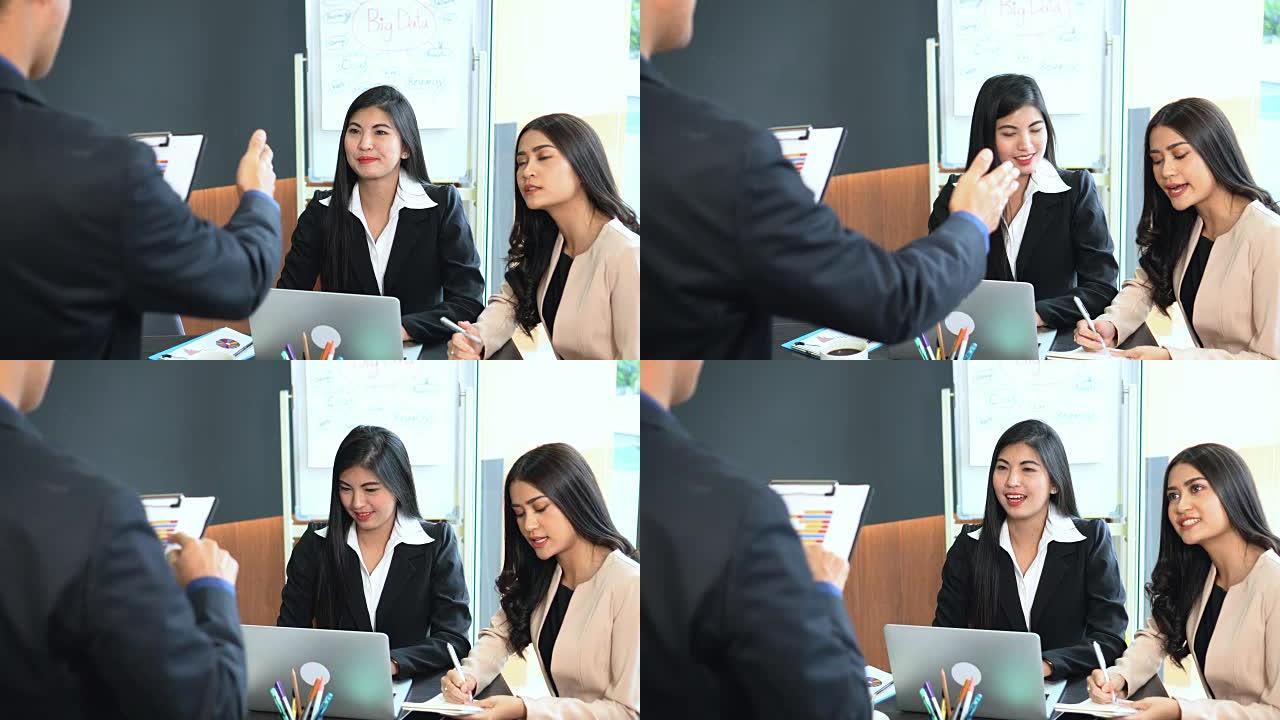亚洲商人的4k镜头场景小组将任务分配给女商人，在办公室，业务和会议上与团队合作并讨论工作计划项目