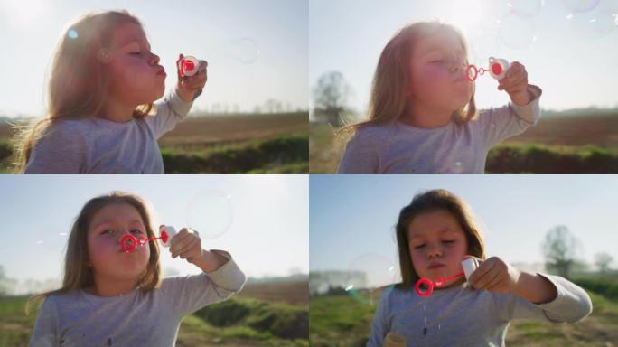 春天公园小女孩吹肥皂泡的真实特写镜头