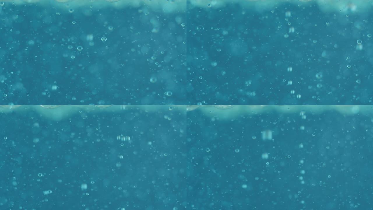 用显微镜分析液体中蓝色微粒分子的慢动作宏观，用于科学实验室的护肤和美容化妆品研究。
