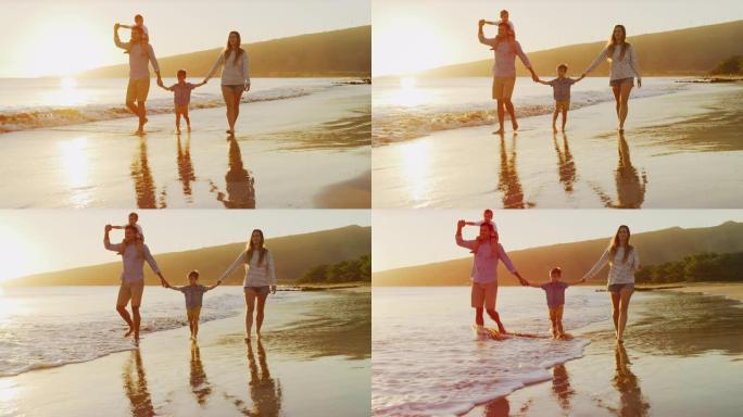 妈妈和爸爸在海滩上挥舞着儿子