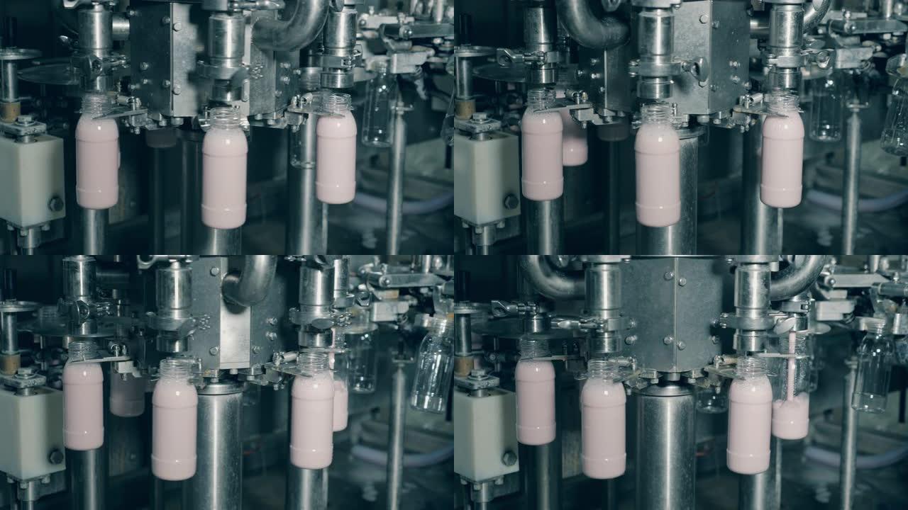生产和包装食品和饮料的自动化设备。工厂设备，工业机器用酸奶灌装瓶。