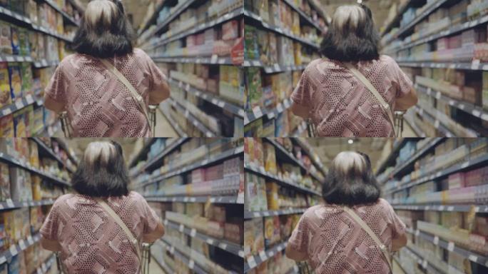 一个成熟的亚洲女人在超市购物