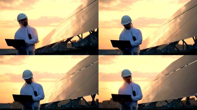 太阳装置和一名男性工程师在日落时在附近工作