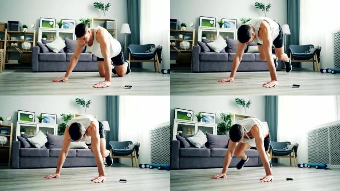 强壮的年轻人在木板位置做有氧运动，独自练习。