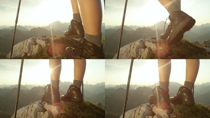 慢动作: 穿着皮革登山靴的女游客到达顶峰。