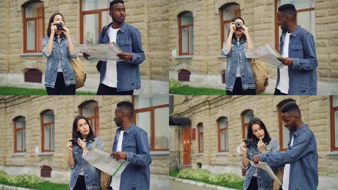 当他迷人的女性朋友站在市中心聊天时，英俊的非洲裔美国男子旅行者正在看地图。