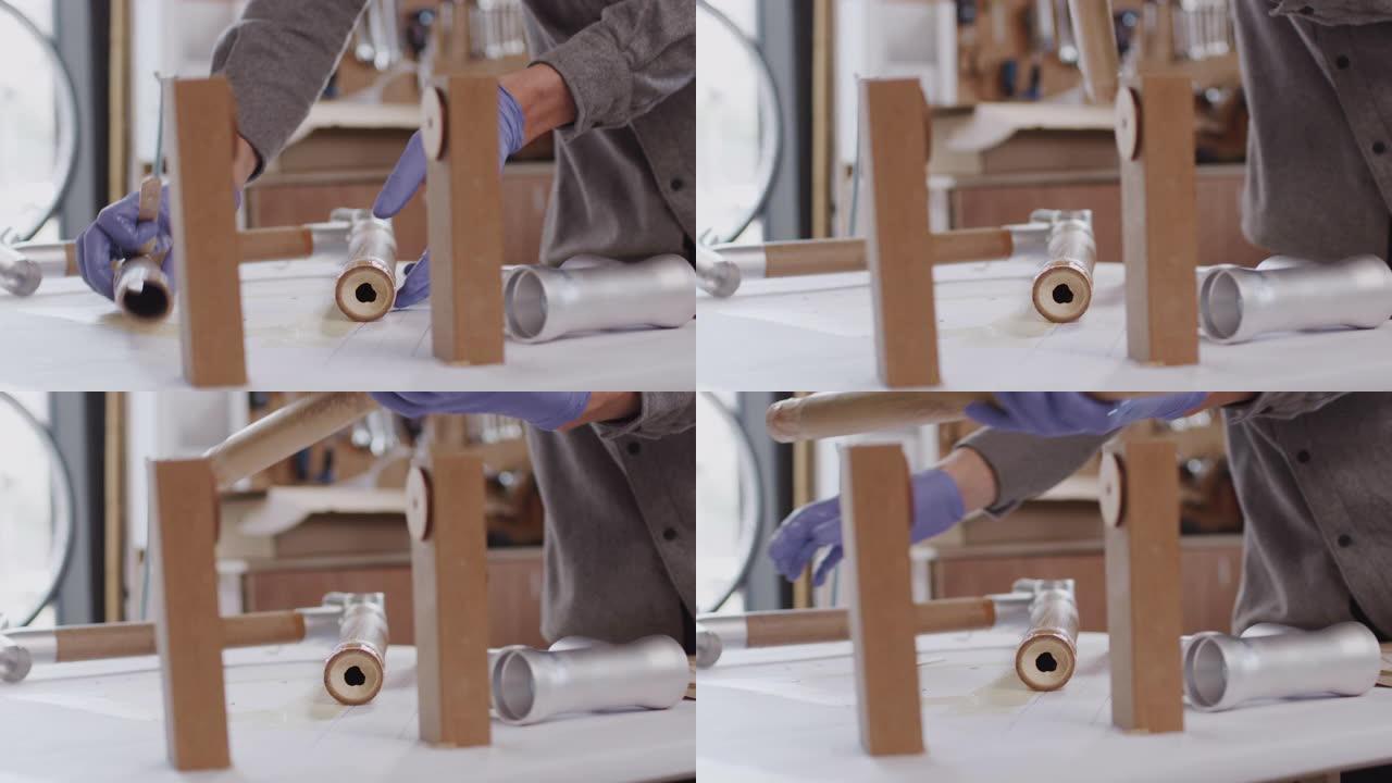 车间男工匠组装手工打造的可持续竹制自行车车架的特写