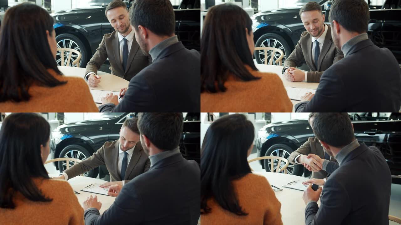 幸福夫妻购车签约做击掌谈销售经理
