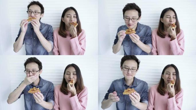 有趣的亚洲夫妇吃披萨