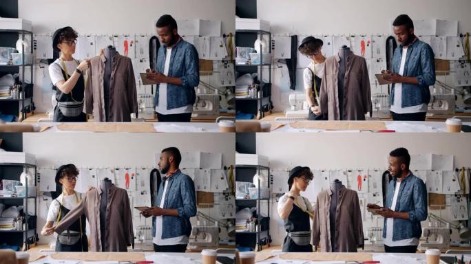 男人和女孩裁缝在笔记本上的虚拟书写尺寸上测量衣服
