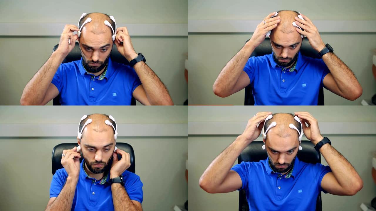 一个戴着脑波扫描耳机的人在用电脑工作。