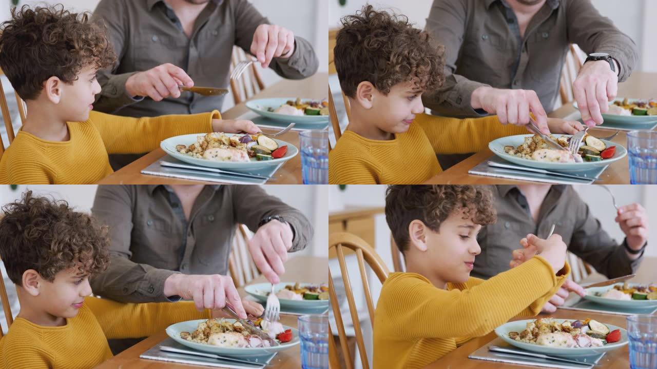 单身父亲帮助儿子在家吃饭时减少食物