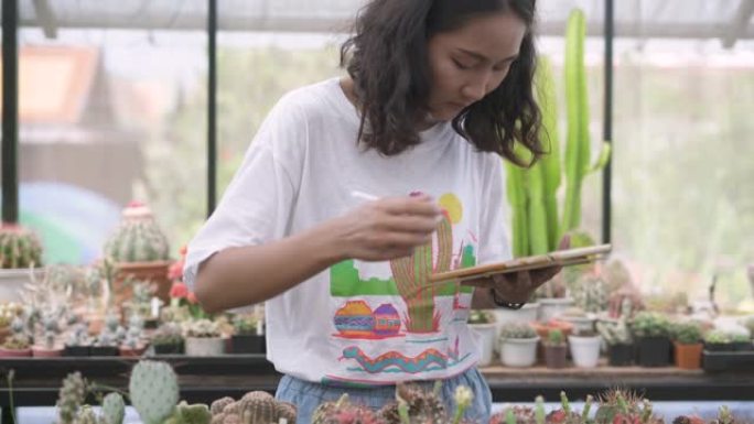 使用数字平板电脑维护仙人掌植物记录的妇女