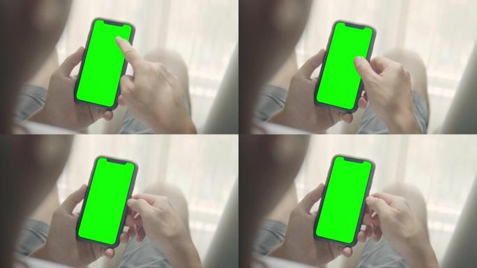 使用智能手机的肩拍，绿屏