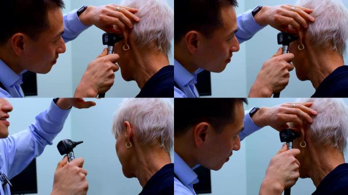年轻的亚洲男医生在诊所检查一名耳镜的高级患者4k