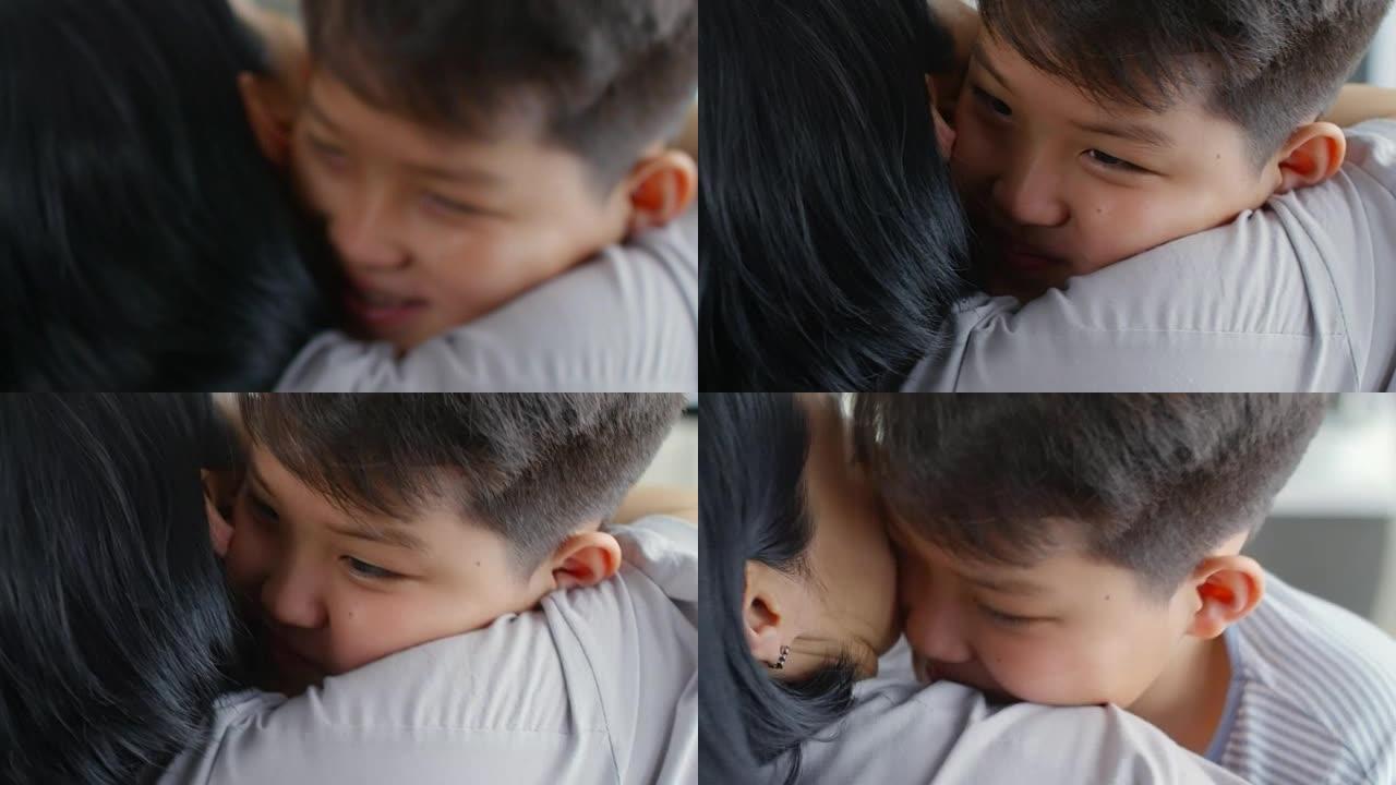拥抱妈妈的亚洲男孩