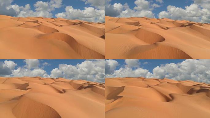 飞越沙漠中无尽的黄色沙丘。沙丘和云密布的蓝天。UHD美丽的沙漠景观鸟瞰图
