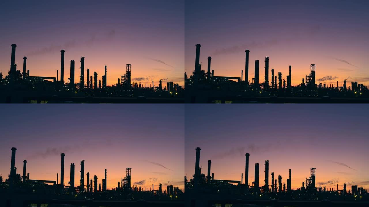 WS剪影的炼油厂塔在日落的天空中