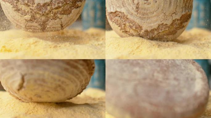 宏观，DOF: 质朴的圆形面包落入一堆粗玉米粉中。