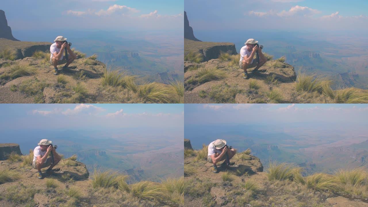 山顶上的人拍照高山美景山顶山峰绿草地