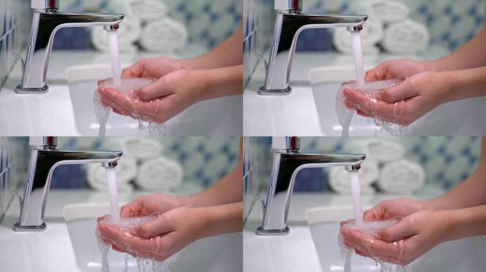 自来水和青少年的手。不用肥皂在水龙头或水龙头下洗手。卫生概念。慢动作