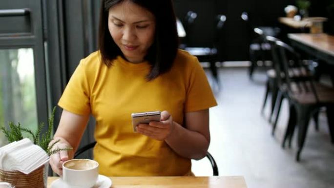 亚洲女子用手机在loft cafe喝咖啡，慢动作