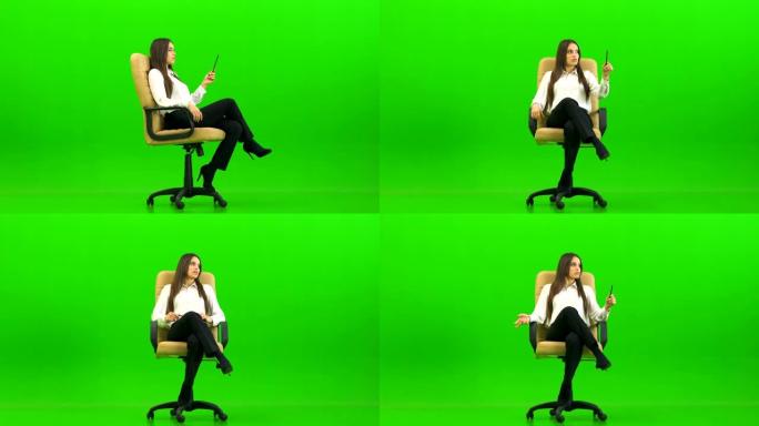 办公室椅子上的美女在绿色背景上聊天