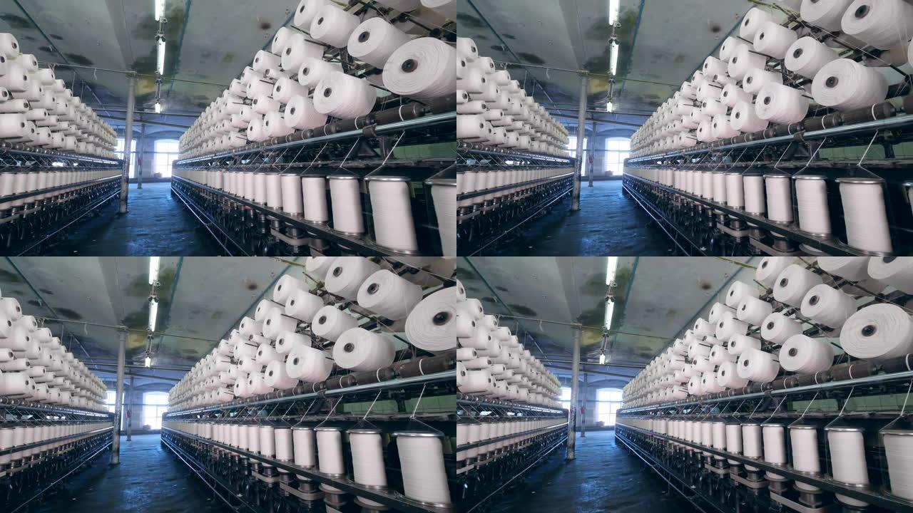现代纺织厂。带有大量旋转缝纫卷轴的工业单元