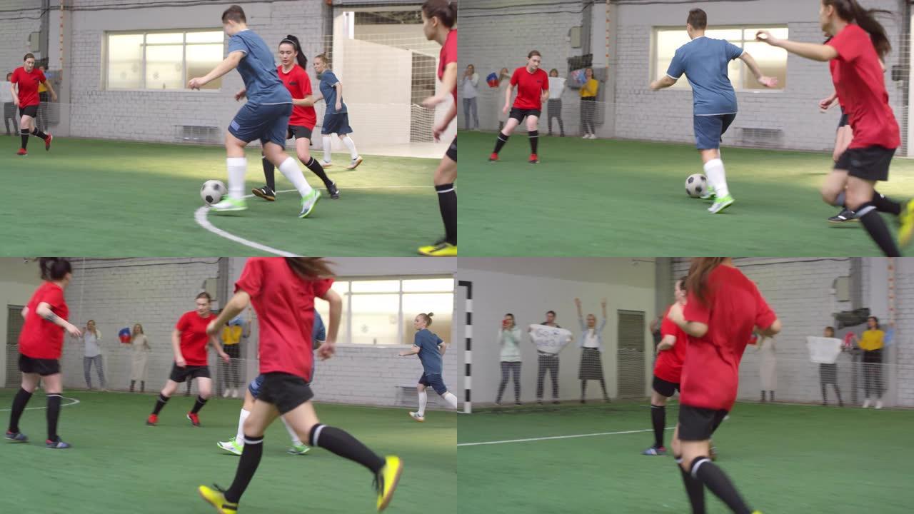女足球运动员在室内比赛中运球和击球