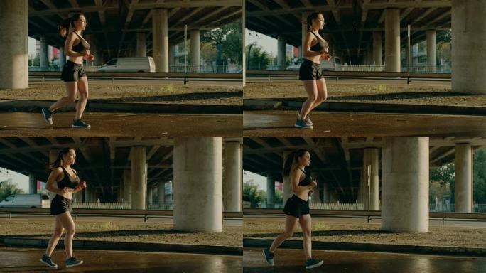 一个穿着黑色运动上衣和短裤的美丽健身女孩的慢动作镜头，在温暖的灯光下在街上慢跑。她在城市环境中奔跑，