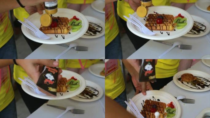 Pouring syrup on a waffle