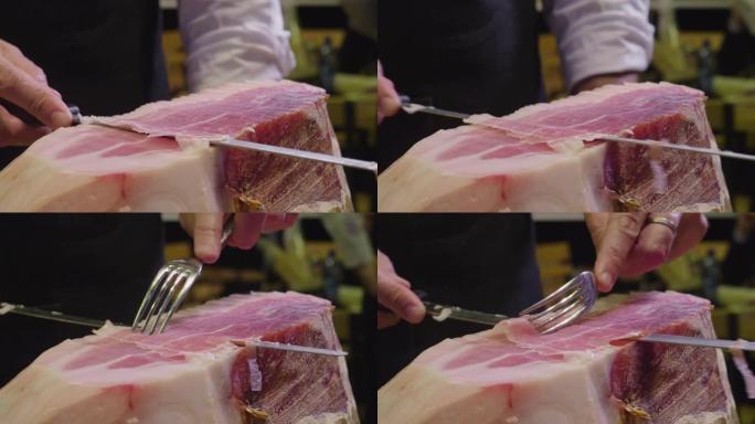 根据传统，用刀切出一块优质火腿的厨师的特写镜头。