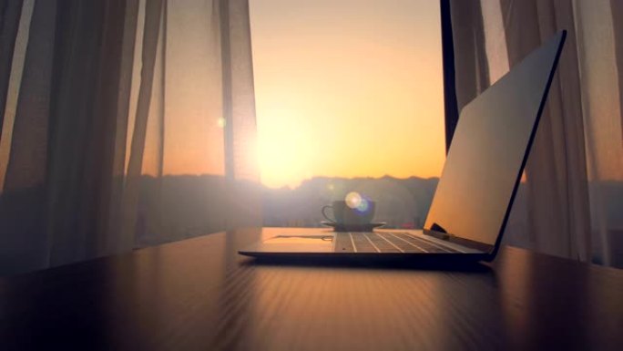 日落时桌上的笔记本电脑和咖啡杯