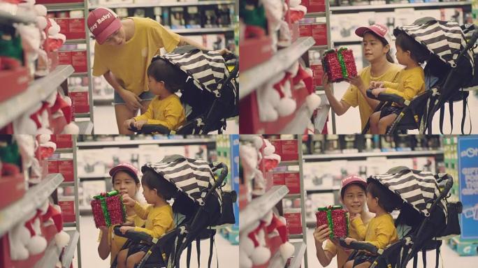 亚洲妇女和男婴在超市购物圣诞节