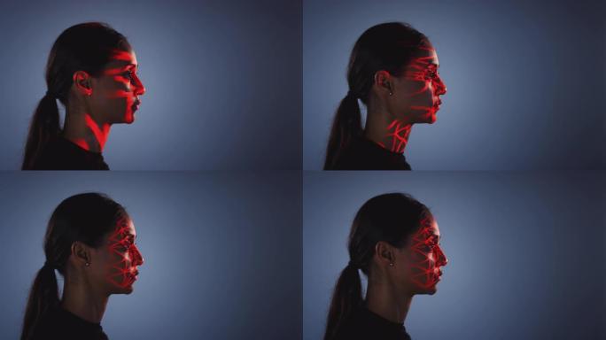 人脸识别技术概念作为女人有红色网格投影到脸部在工作室