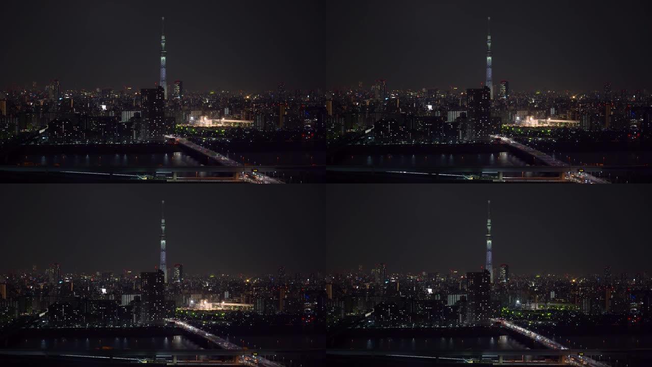 东京天空树的4k镜头场景定位于各种建筑的城市景观和交通路口，在夜间高峰时间，日本，城市景观和交通概念
