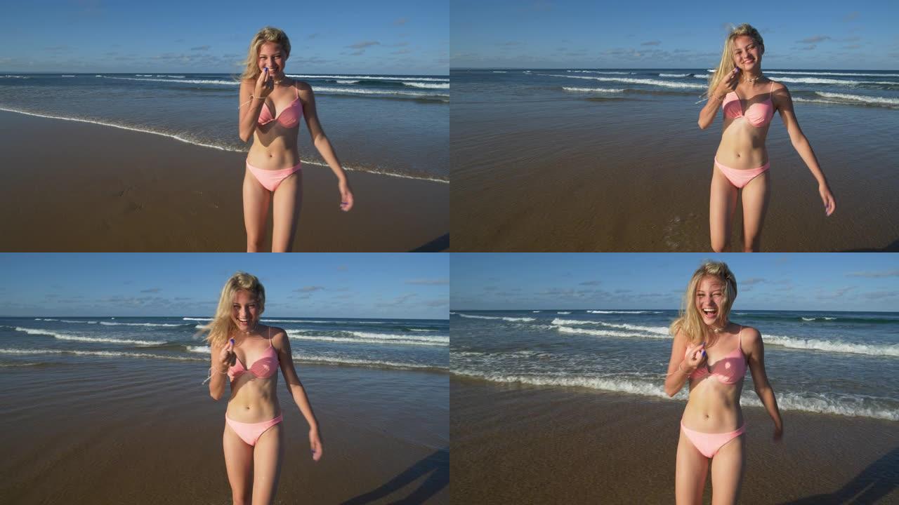 南非，一个美丽的年轻女子调情地呼唤某人进入海浪寻找乐趣的4k视图