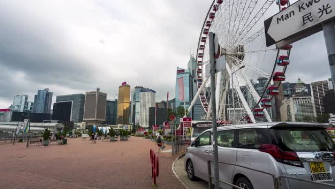 4K UHD延时: 香港中区的摩天轮和城市现代城市景观背景。