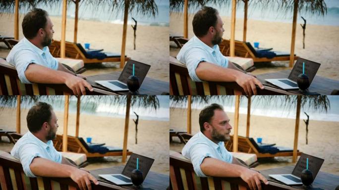 成功内容商人的中景照片坐在异国情调的沙滩躺椅上，笔记本电脑在海洋度假村放松。