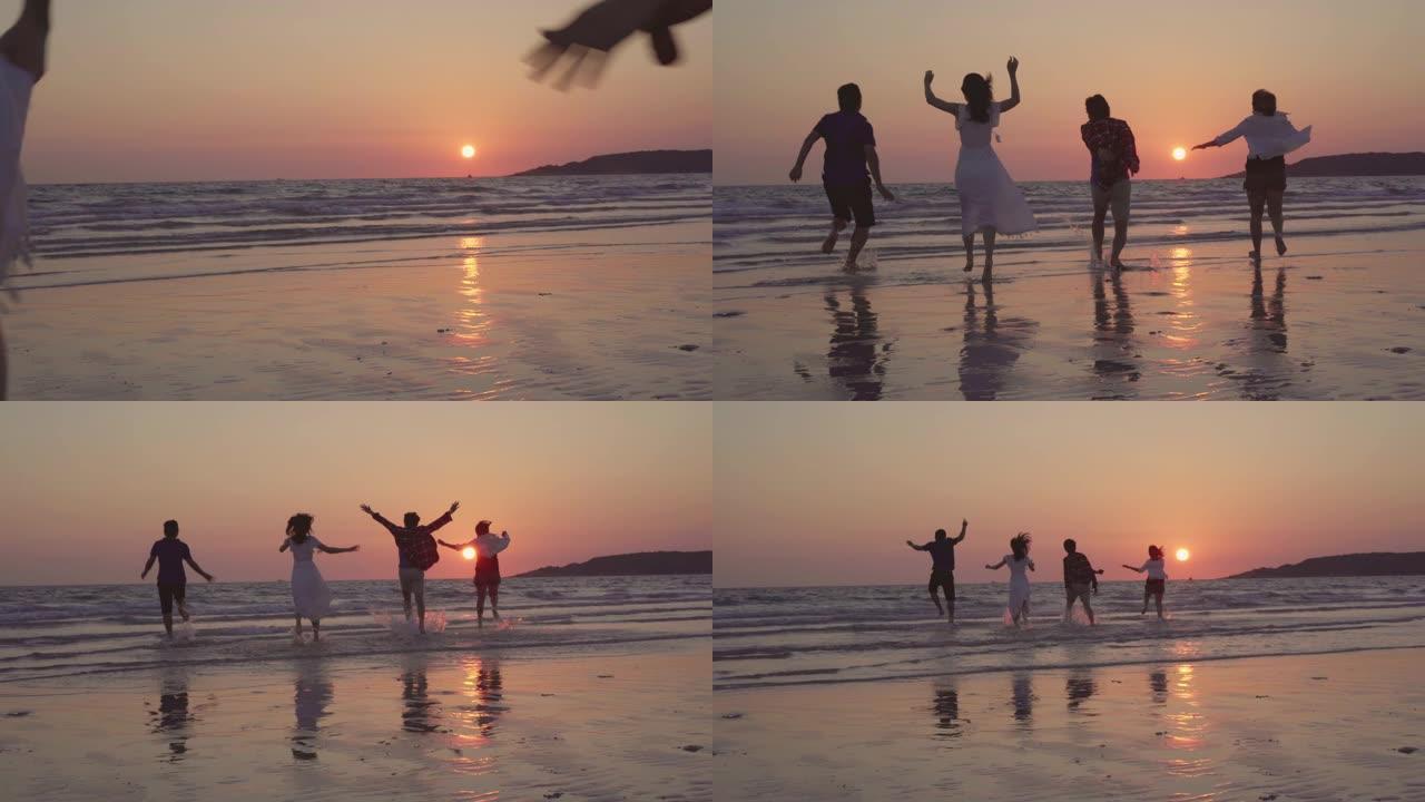 年轻的亚洲人在海边奔跑，朋友们在傍晚日落时在海边的海滩上玩耍，开心地放松。生活方式朋友在海滩上旅行的