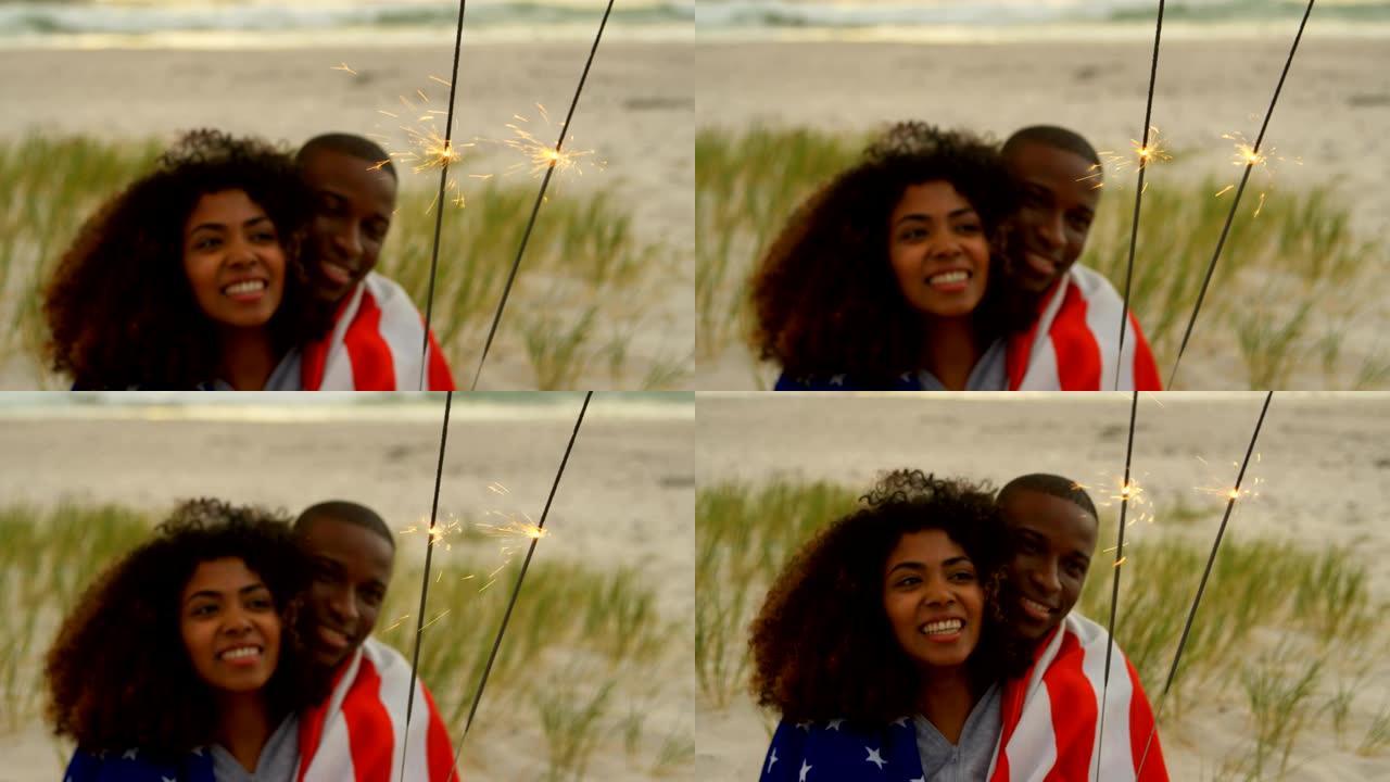 非裔美国夫妇在4k海滩手持烟火的前视图