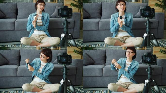 女性博客作者录制有关在公寓中使用相机的数字手表的视频