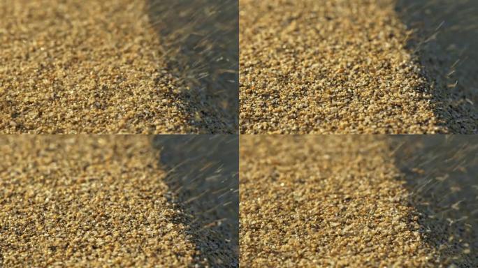 沙粒在风中飘扬。谷物像谷物一样飞走的抽象观点。慢动作镜头