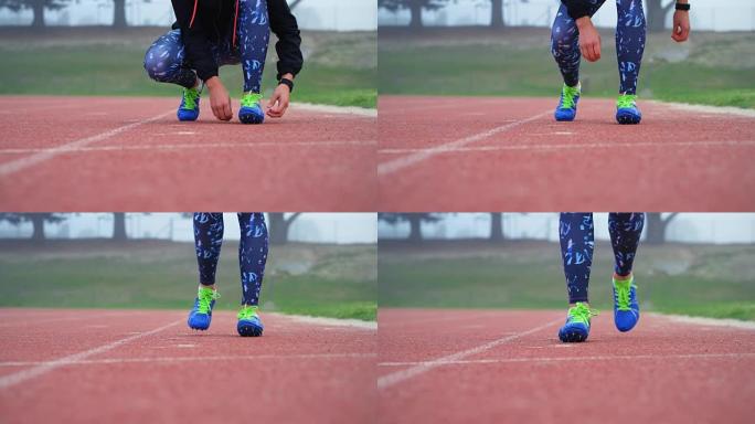 女子运动员在跑道上系鞋带4k