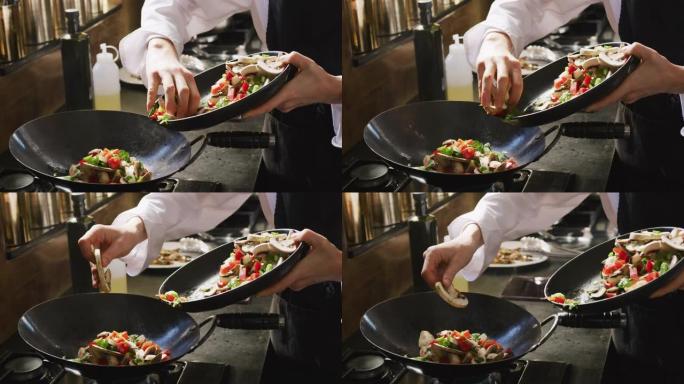 厨师在锅上添加蔬菜