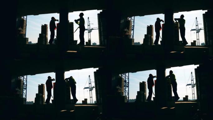 男性工程师持有的砖墙施工