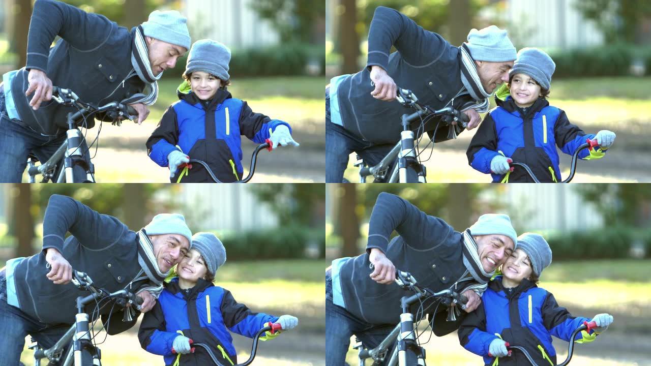 西班牙裔父亲和儿子在公园骑自行车