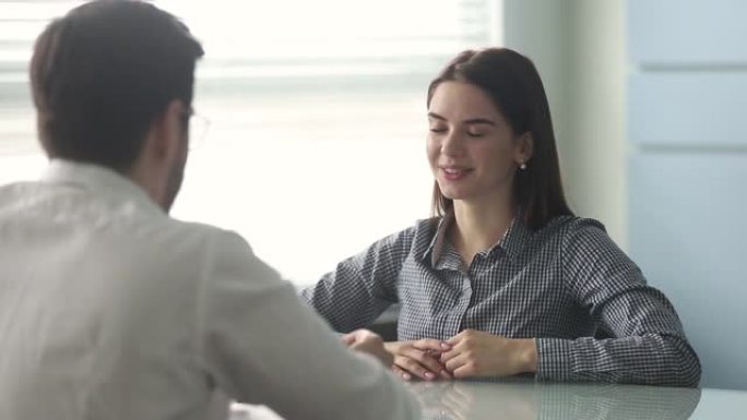 自信的年轻女性申请人与人力资源经理握手