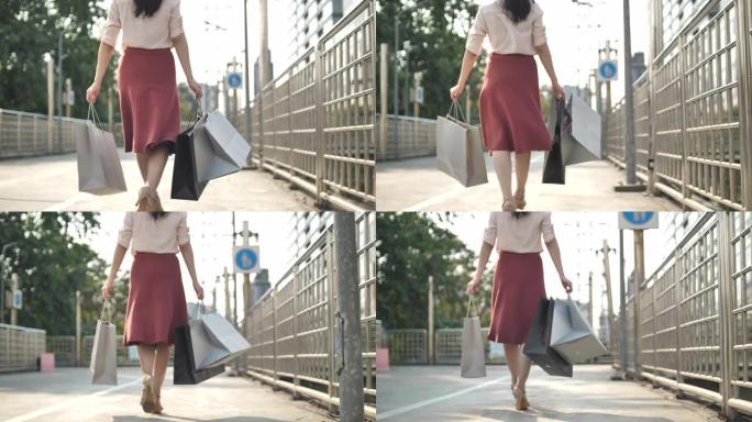 带着购物袋走路的女人的腿，购物概念